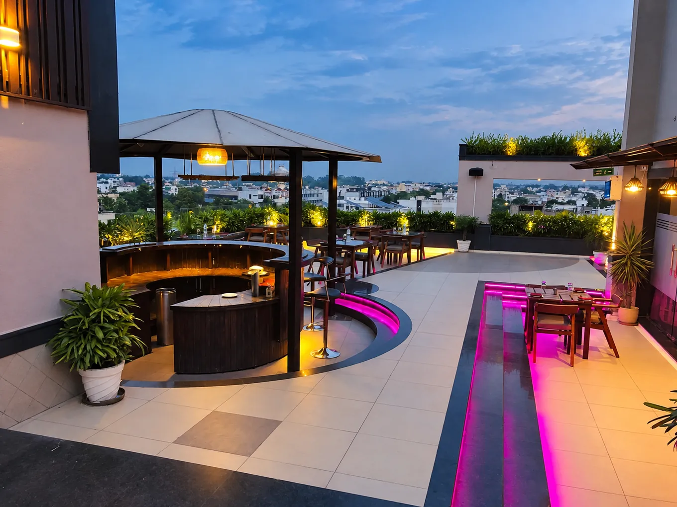 Rooftop dining terrace with a circular bar and city views at dusk